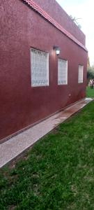 a red building with two windows on the side of it at Villa à louer dans un endroit magnifique in Tifnit