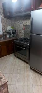 a kitchen with a stove and a refrigerator at Villa à louer dans un endroit magnifique in Tifnit