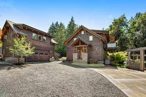 a house with a driveway in front of it at Bainbridge Island Timber Retreat in Fort Ward