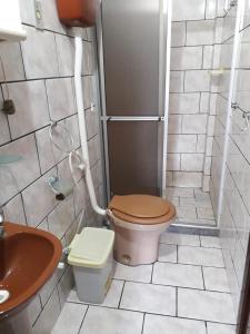 a bathroom with a toilet and a sink at Casas e kitnetes em Praia de Guaibim in São Fidélis +25 photos