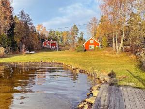 BjörköにあるHoliday home BJÖRKÖ IIIの赤家の家の前の池