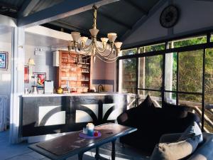 a living room with a couch and a table at Sunbloom Beachfront Hotel and Restaurant Zambales in Sinabacan