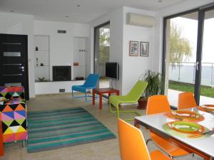 a living room with colorful chairs and a table at The Beach House in Sozopol