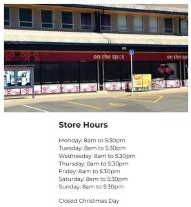 a store hours sign in front of a building at Home Away from Home - Waitaki Lakes Apartment A5 in Otematata