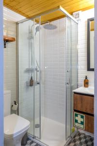 a bathroom with a shower with a toilet and a sink at Casa do Tio Ferreiro in Sabugueiro
