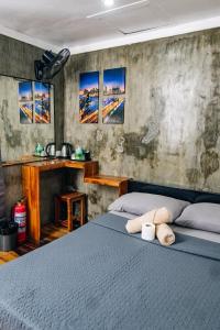 a bedroom with a bed with two towels on it at OKEANOS HOTEL in Moalboal