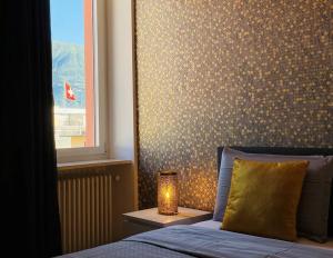 a bedroom with a bed and a lamp on a table at GIOIA@HOME in Locarno