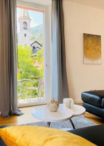 a living room with a table and a large window at GIOIA@HOME in Locarno
