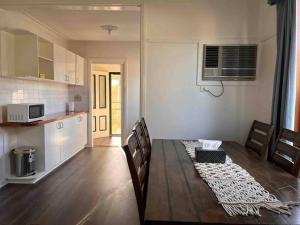 a kitchen and dining room with a table and chairs at Cheerful 2 bedroom house with a beautiful veranda in Geelong