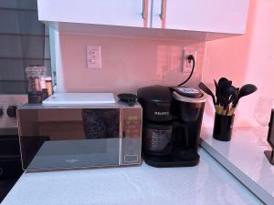 a kitchen counter with a microwave and a coffee maker at Whole House by Beach - Relaxing & Family Friendly! 