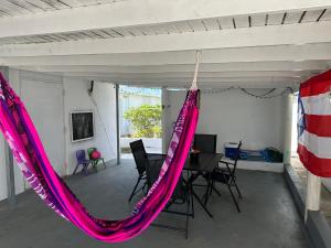 a hammock in a room with a table and chairs at Whole House by Beach - Relaxing & Family Friendly! 