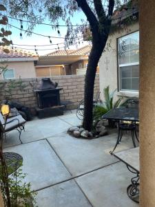 a patio with a table and a fire place at Quaint Cochella Music Festival Casita in Indio