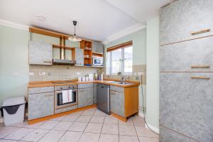 a large kitchen with a sink and a refrigerator at 6 Bedroom Larger group House with Parking Corringham Stanford Le Hope in Horndon on the Hill