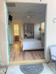 a bedroom with a bed and a table in a room at Quaint Cochella Music Festival Casita in Indio
