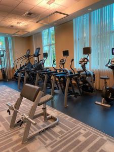 a gym with several treadmills and elliptical machines at Balcony Suite Strip View in Las Vegas