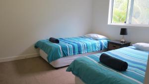 Katil atau katil-katil dalam bilik di Villa 31 Tangalooma Beach Front