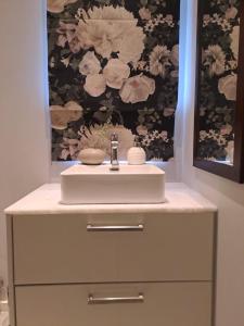 a bathroom with a white sink and a drawer at Oak Village in Stellenbosch
