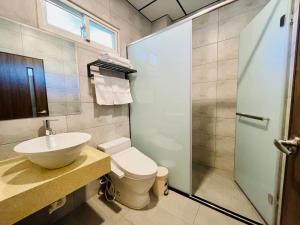 a bathroom with a sink and a toilet and a shower at Junyi Landscape Villa in Ren'ai