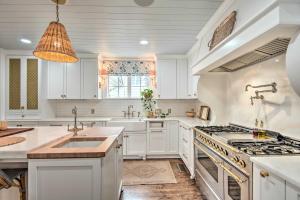 a kitchen with white cabinets and a stove top oven at Stunning Charlotte Home Private Pool! in Charlotte
