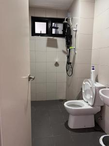 a bathroom with a toilet and a phone on the wall at D Bunga 1 MOSLIM Homestay Pool View Legoland Nusajaya in Nusajaya