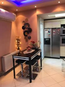 a kitchen with a table and a refrigerator at Apartament in Aridaia