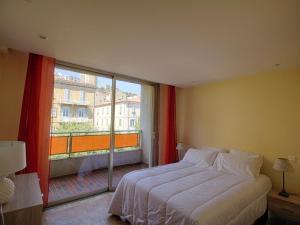 Appartement Ajaccio, 4 pièces, 6 personnes - FR-1-61-509 في أجاكسيو: غرفة نوم بسرير ونافذة كبيرة