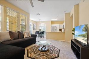 a living room with a couch and a flat screen tv at Luxury 2BR/2BA!5Min to Disney! Angelstadium! HondaCenter. in Anaheim
