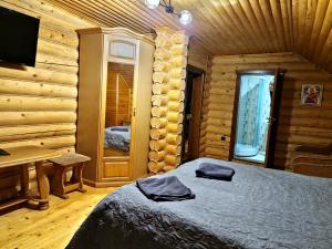 sypialnia z łóżkiem, biurkiem i telewizorem w obiekcie Gostynniy Dvir Коттеджи w mieście Migowo