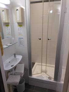 a bathroom with a shower and a sink at Hôtel de France La Teste Arcachon in La Teste-de-Buch