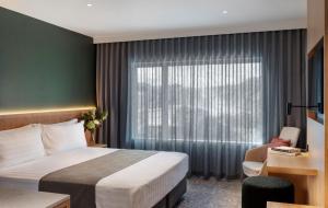 a hotel room with a bed and a window at Rydges Rotorua in Rotorua