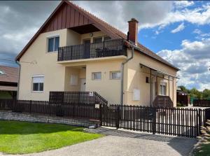 a house with a black fence in front of it at Apartment in Balatonbereny/Balaton 18061 in Balatonberény