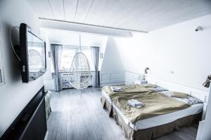 a bedroom with two beds and a flat screen tv at Willa Carlton in Zakopane