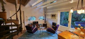 a living room with purple chairs and a table at Wonderland in Pieterburen +36 photos