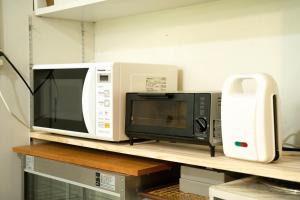 a microwave and a toaster oven on a shelf at Ashigarashimo-gun - Hotel - Vacation STAY 53658v in Onsensō