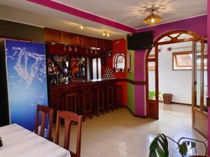 a bar in a restaurant with colorful walls at Antsirabe Hotel in Antsirabe