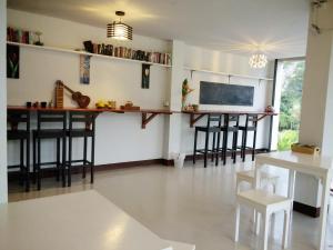 a living room with a bar and stools at Lom La Lanta in Ko Lanta