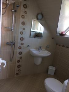 a bathroom with a sink and a shower and a toilet at Studio Stoianovi in Nesebar