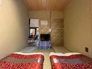 Postel nebo postele na pokoji v ubytování 至の宿-京都南 Traditional Machiya Guesthouse