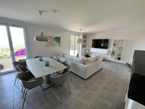 ein Wohnzimmer mit einem weißen Sofa und einem Tisch in der Unterkunft Fantastic villa in the bay of Cannes, 5 minutes from the beach - with heated private pool in Mandelieu-la-Napoule