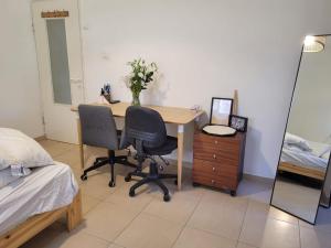 a bedroom with a desk and two chairs and a bed at The house in Jerusalem in Jerusalem