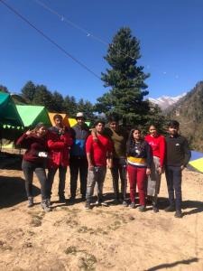 a group of people are posing for a picture at City Escape Camps and Cafe Kheerganga in Kheerganga