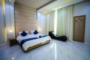 a bedroom with a large bed and a mirror at Arjan Park Resorts in Riyadh