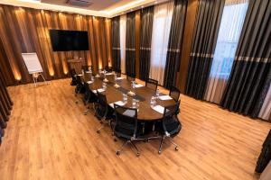 a large conference room with a long table and chairs at Al Yarmouk International Hotel in Baghdād