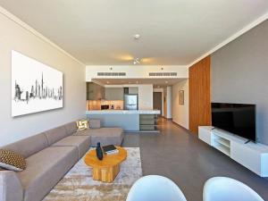 a living room with a couch and a table at Modern Urban 3 bedroom apartment Dubai Creek Harbour in Dubai