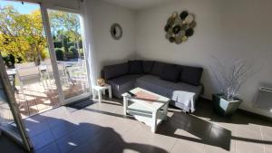 a living room with a couch and a table at maison village vacances demeures du Ventoux in Aubignan