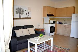 a living room with a couch and a table at Kakia 2 Bedroom Apartment in Zakynthos