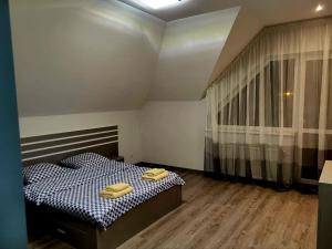 a bedroom with a bed with two yellow towels on it at NEW апартаменты на Гвардейской in Uzhhorod