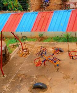 a group of swings in front of a building at Malindi luxury apartment. in Malindi