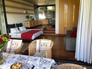 a room with a bed and two tables and chairs at Snooze in Hout Bay Self-Catering in Hout Bay