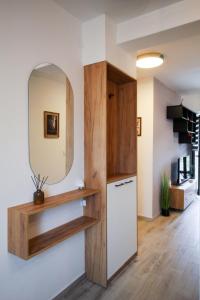a kitchen with a mirror and a white refrigerator at Apartman Maslacak in Divčibare